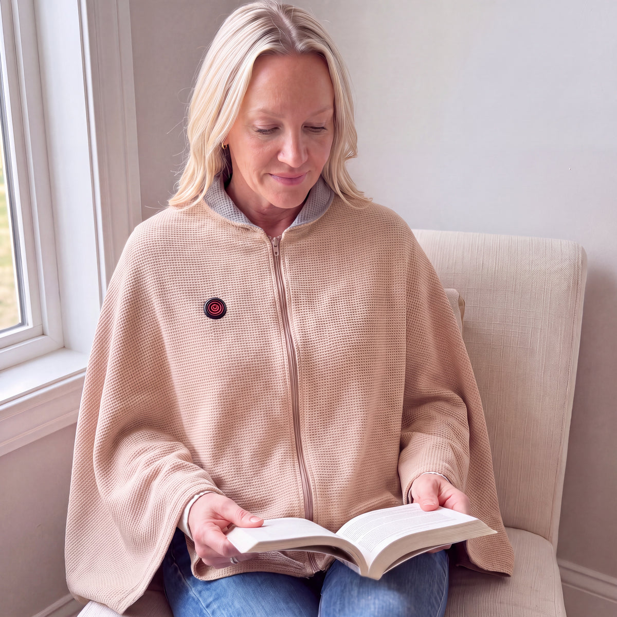 Illustrative reading photo: blonde reader in the Apricot CozyCovers cape with continuous drape and red wearer-right control